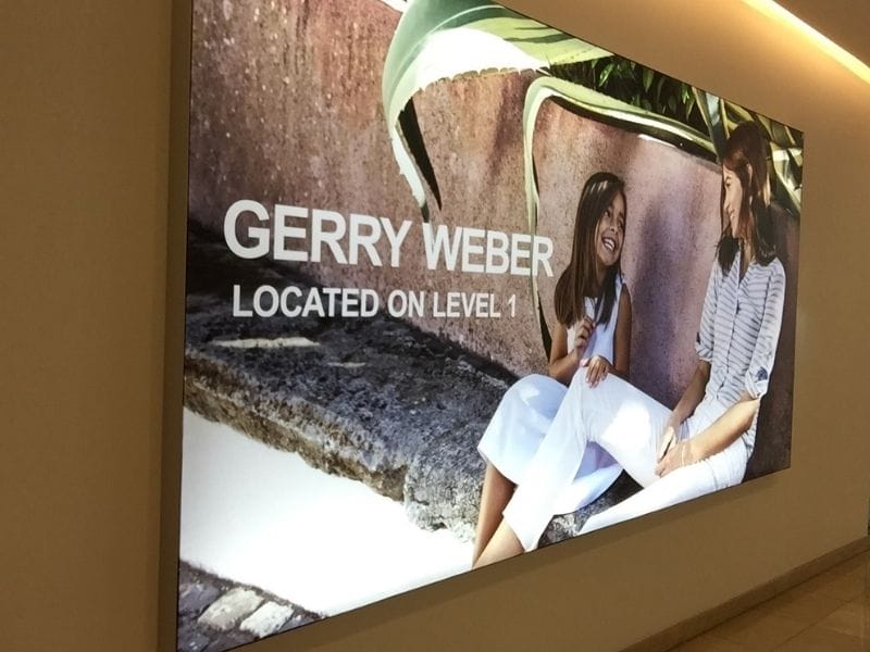 Illuminated wall-mounted Brandframe for shopping mall - Displays2Go