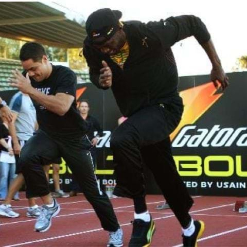Usain Bolt training session at Olympic Park, featuring Jarryd Hayne and backdrop signage - Displays2Go