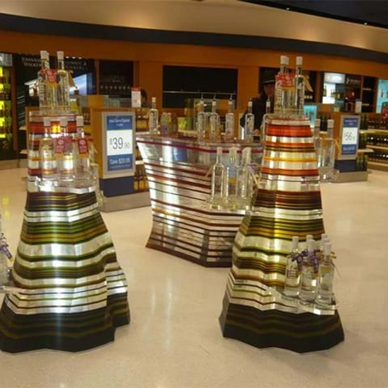 Layered acrylic stands for airport duty free store - stunning! - Displays2Go