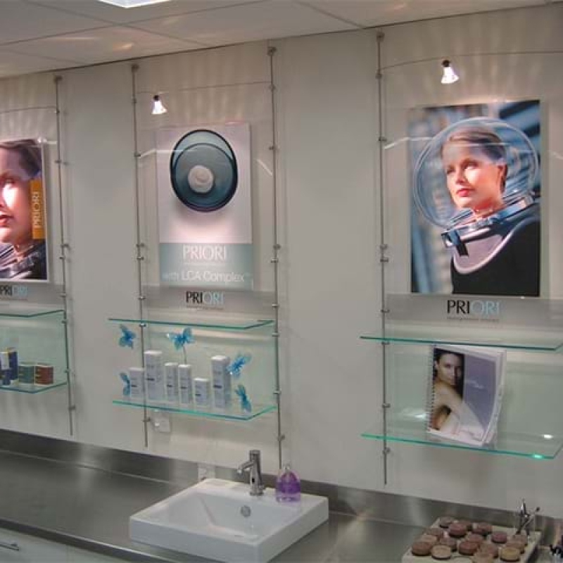 Wall display system with clear shelves and wire supports - Displays2Go